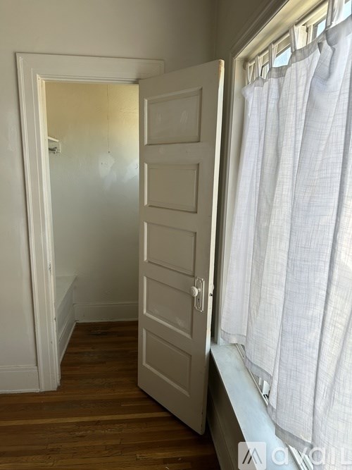 A white door is open to a hallway.