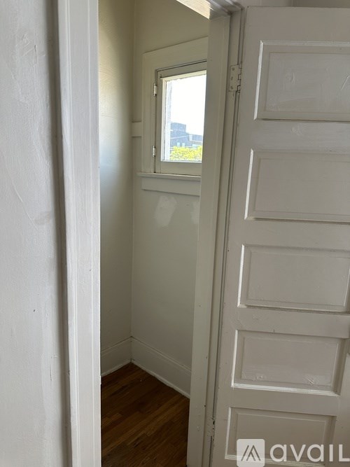 A white door with a window above it.