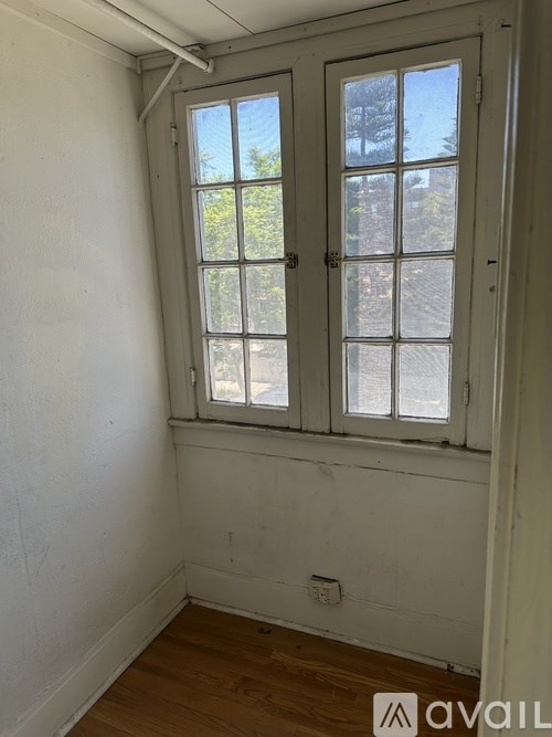 A room with a window and a door.
