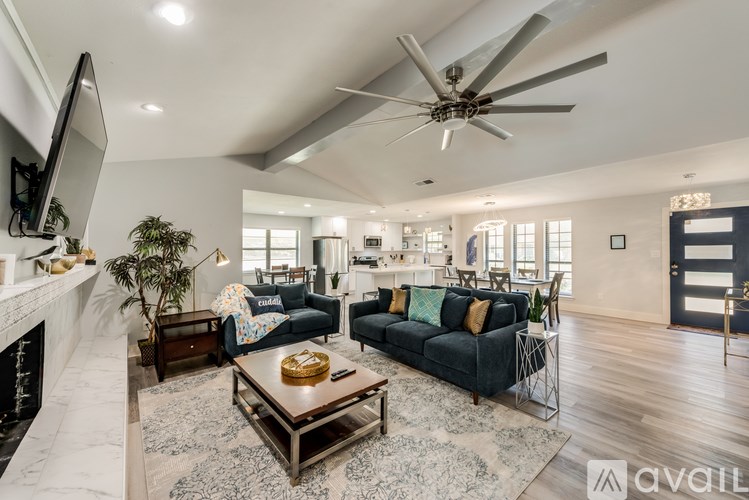 A modern living room with a fireplace and a large sofa.