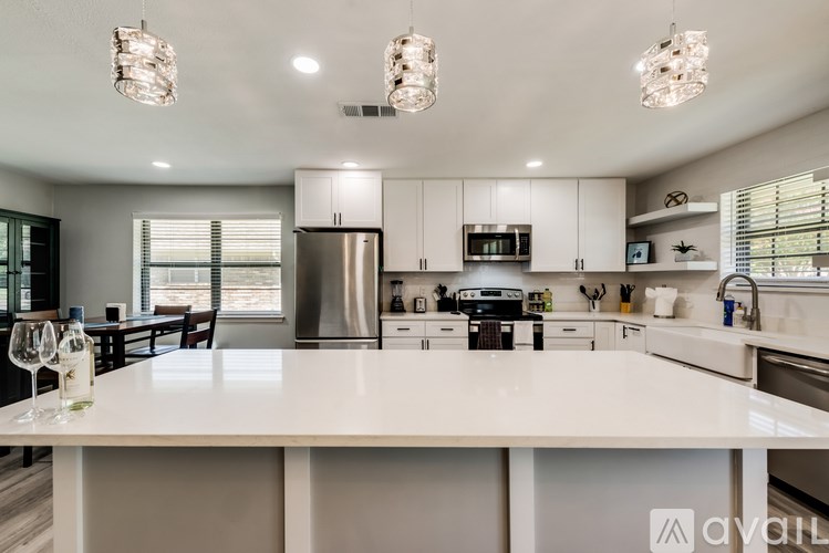 A modern kitchen with a large island and stainless steel appliances.