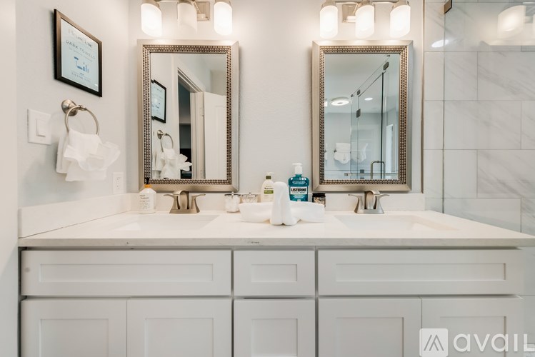 A bathroom with two sinks and two mirrors.