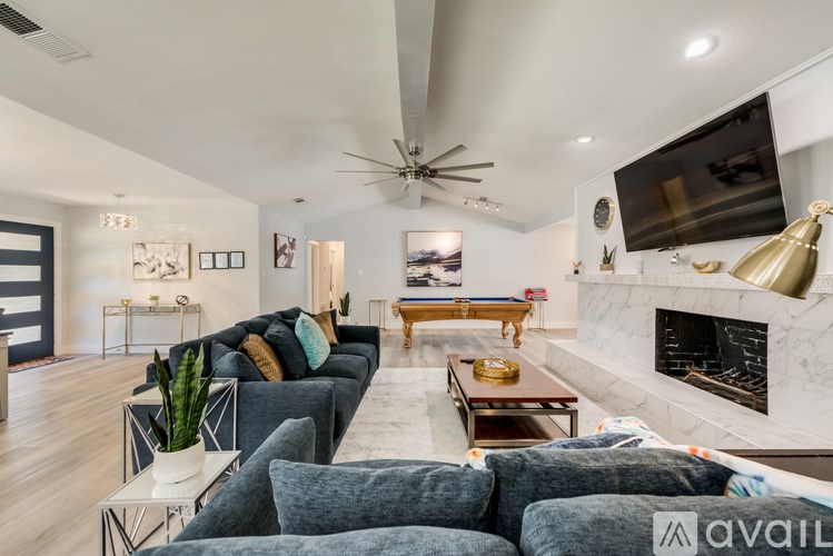 A modern living room with a fireplace and a television.