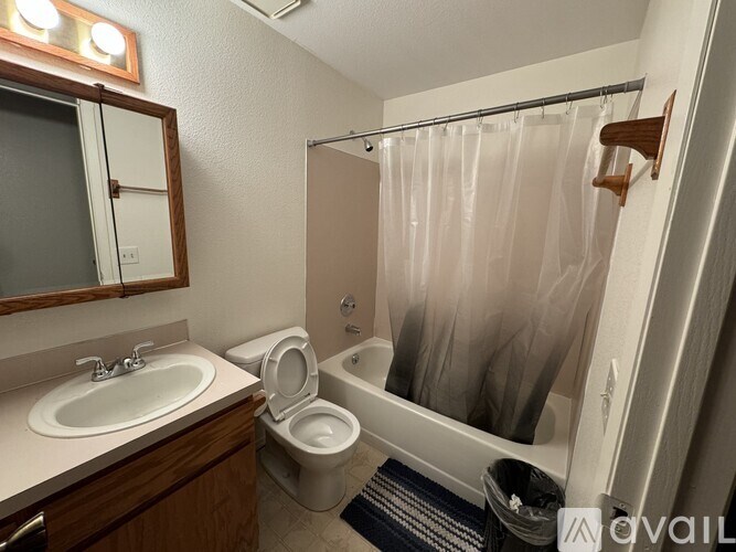 A bathroom with a toilet, sink, and bathtub.