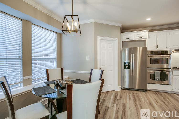 A modern kitchen with a dining table and chairs.