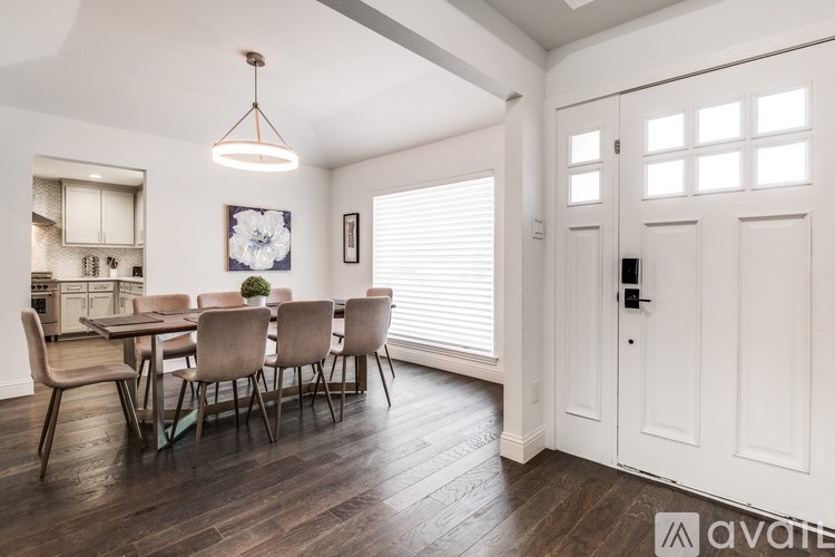 A dining room with a table and chairs.