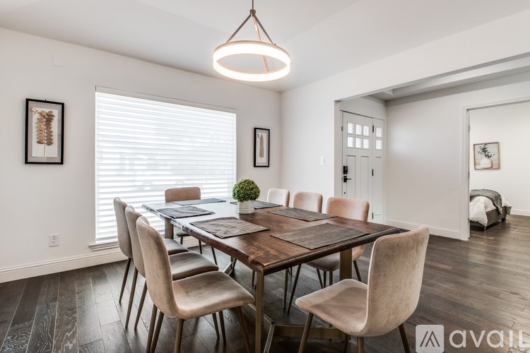 A dining room with a wooden table and chairs.