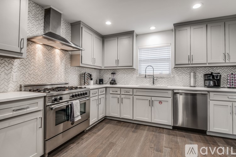 A modern kitchen with a stainless steel dishwasher and oven.
