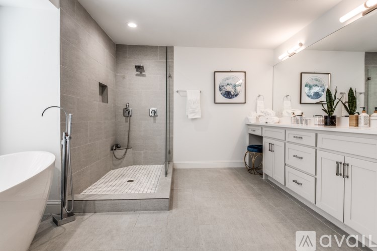 A bathroom with a white tub and a walk-in shower.