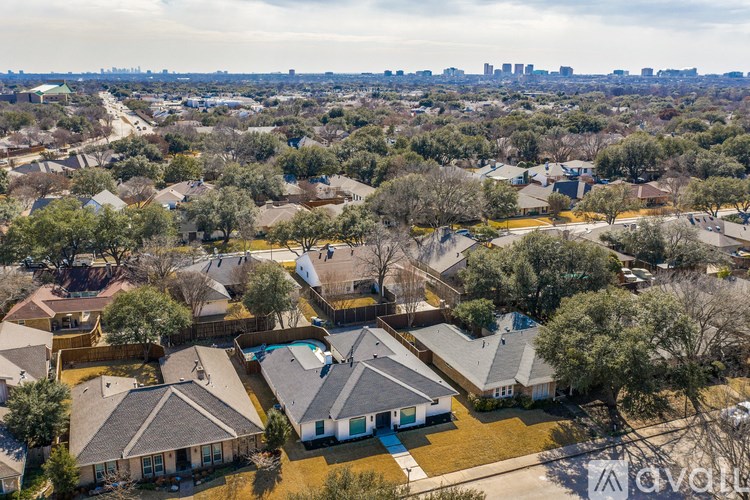 A suburban neighborhood with houses and a pool in the foreground.