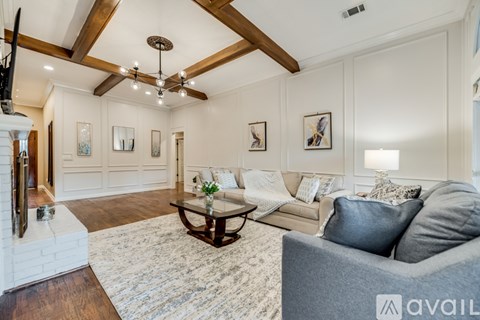 A living room with a grey couch and a coffee table.