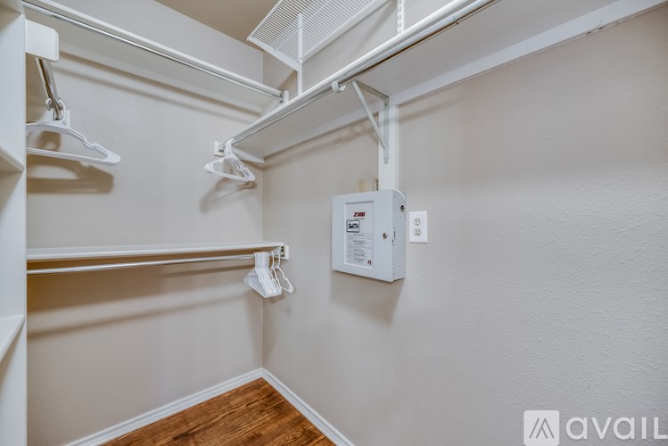 A white wall with a white pipe and a white box on it.