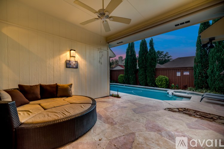 A patio with a couch and a pool table.