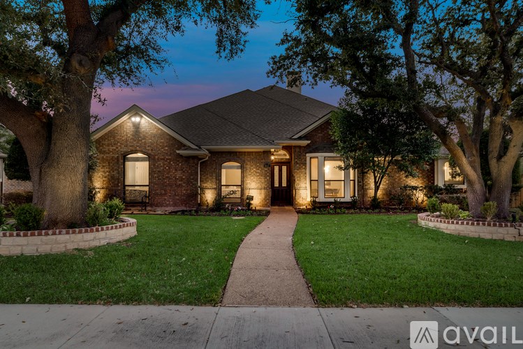 A house with a front yard and a walkway leading to the front door.