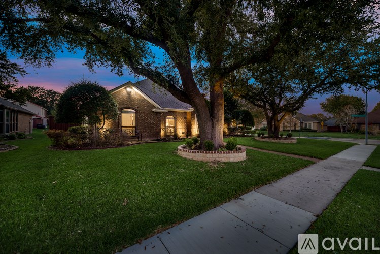 A house with a tree in front of it is available for sale.