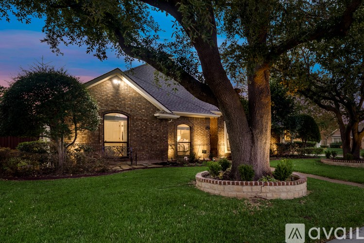A house with a tree in front of it.