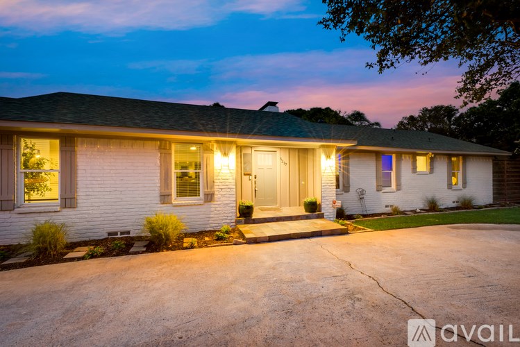 A house with a driveway and a front yard is shown.