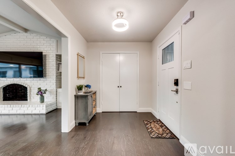 A modern living room with a fireplace and a rug on the floor.