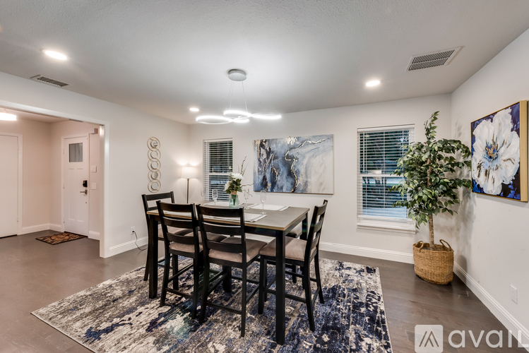 A dining room with a table set for four.