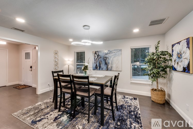 A dining room with a table set for four.