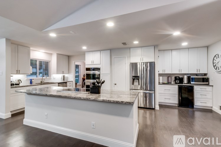 A modern kitchen with a large island in the center.