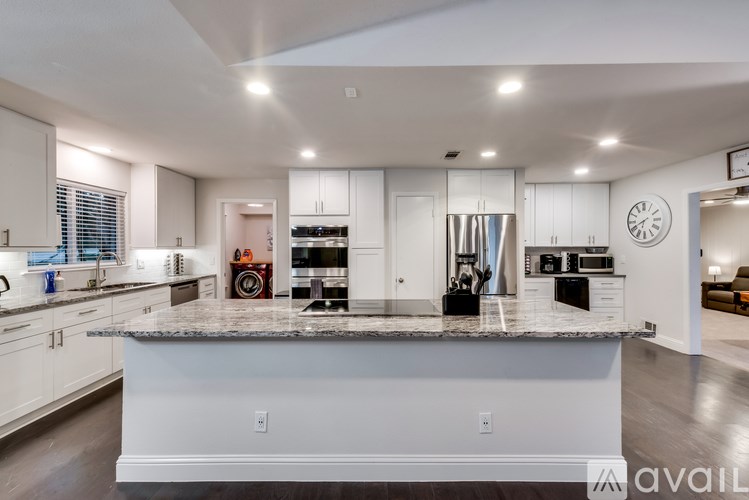 A modern kitchen with a large island in the center.