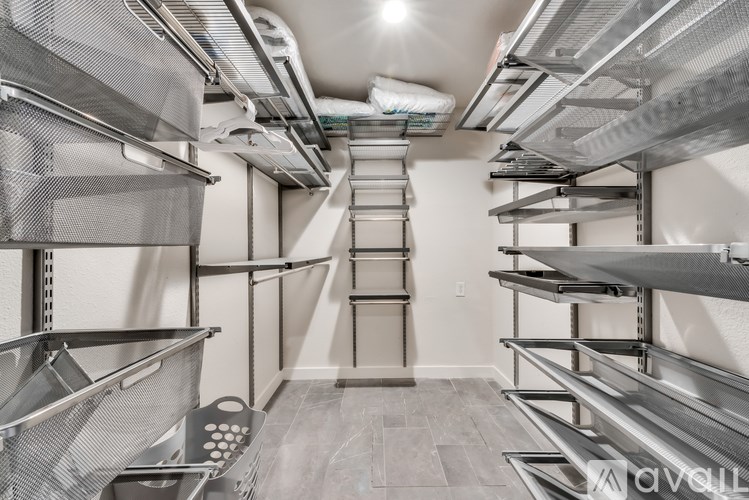 A storage room with metal shelving units and a tiled floor.