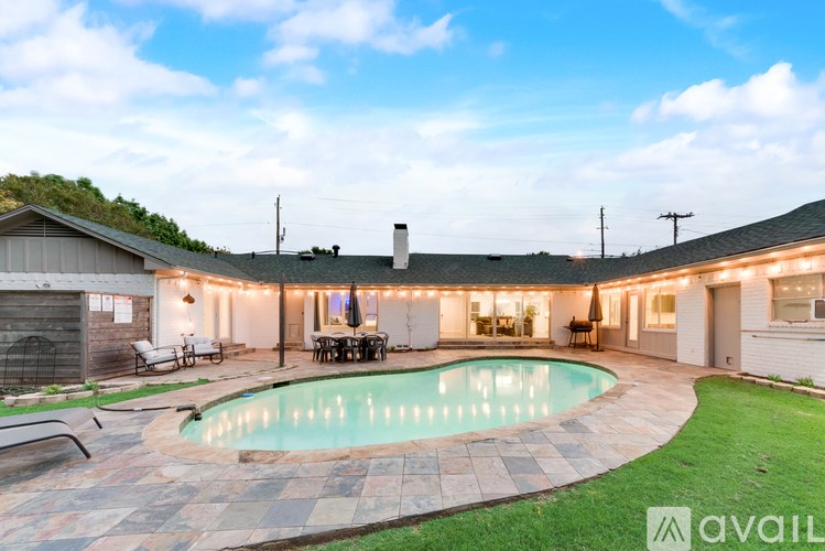 A house with a pool in the backyard.