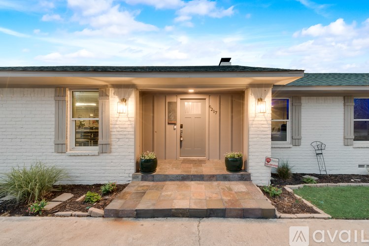 A house with a front yard and a porch.