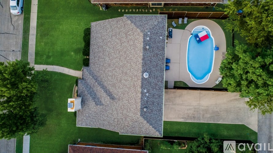 A swimming pool with a slide and a small building.
