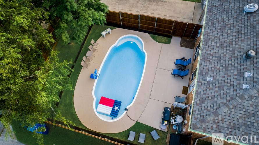 An aerial view of a pool with a Texas flag in the middle.