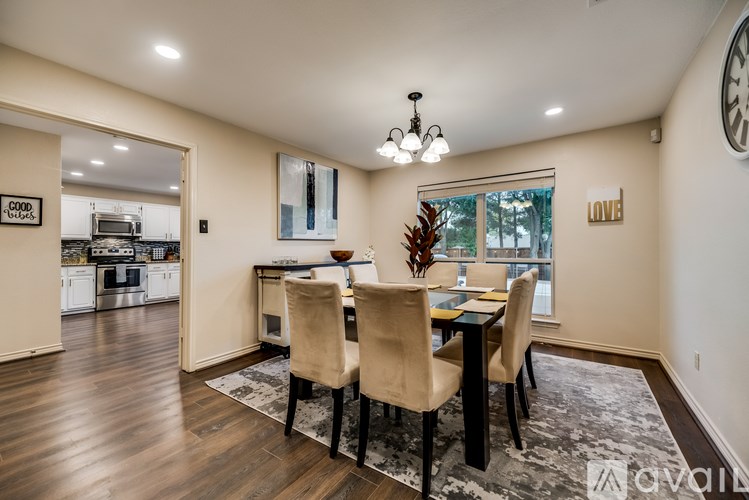 A dining room with a table and chairs.