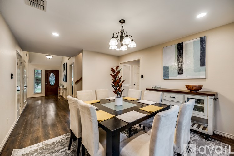 A dining room with a table set for four.