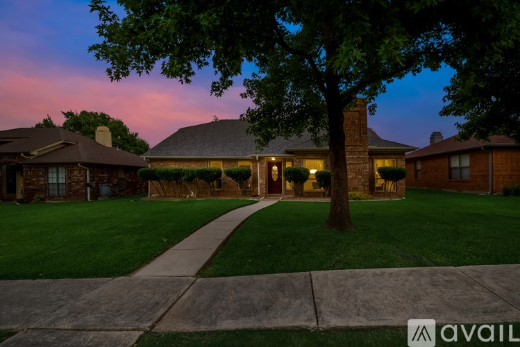 A house with a tree in front of it.