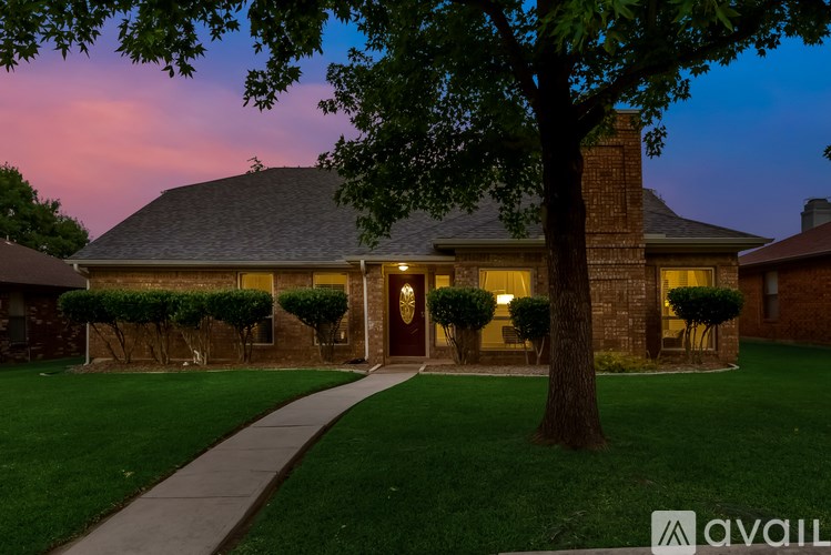 A house with a tree in front of it.