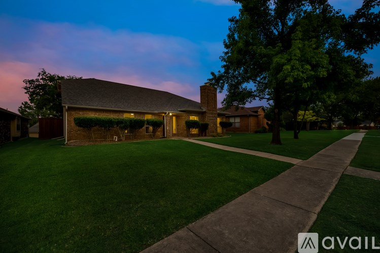 A house with a lawn in front of it is shown.
