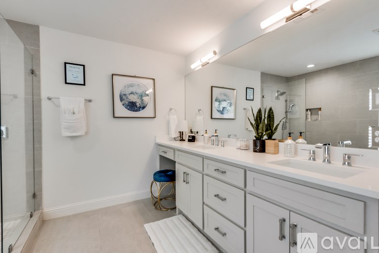 A bathroom with a white counter and a mirror above it.