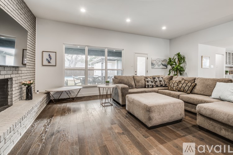 A modern living room with a fireplace and a large couch.