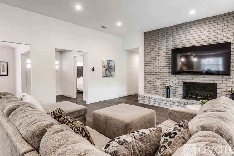 A living room with a fireplace and a television.