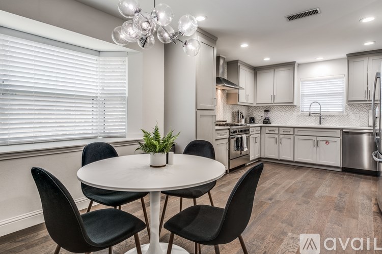 A modern kitchen with a dining table and chairs.