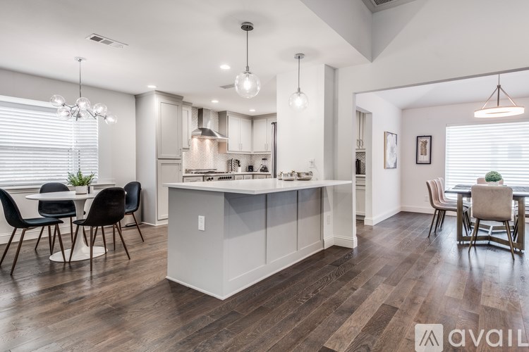A modern kitchen with a dining area and a large island.