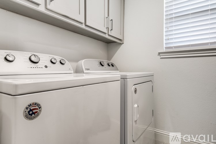 A white washing machine and dryer with a sticker that says "America" on the front of the washing machine.