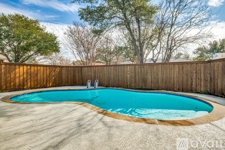 A small above ground pool surrounded by a wooden fence.
