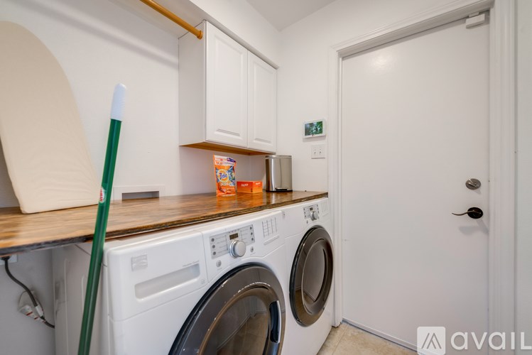 A white washing machine and dryer in a small laundry room.