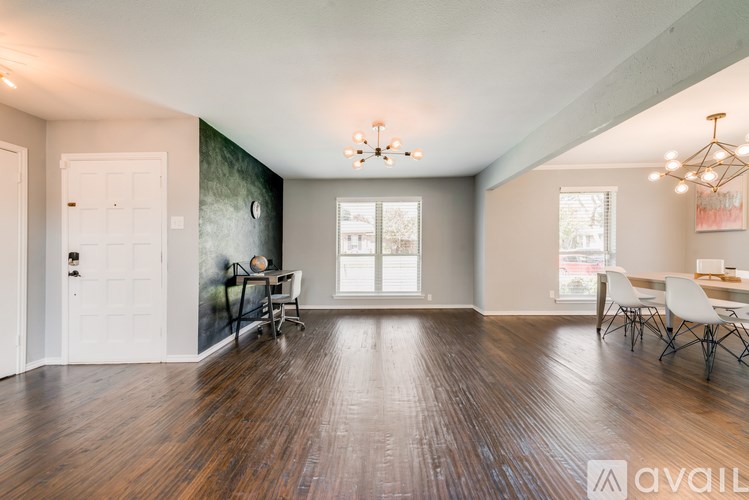 A room with wooden floors and a white door.