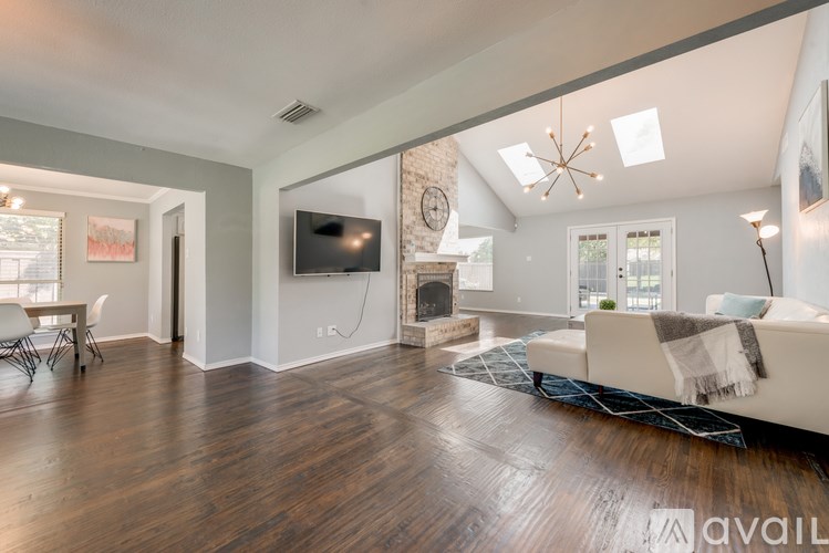 A living room with a white couch and a television.