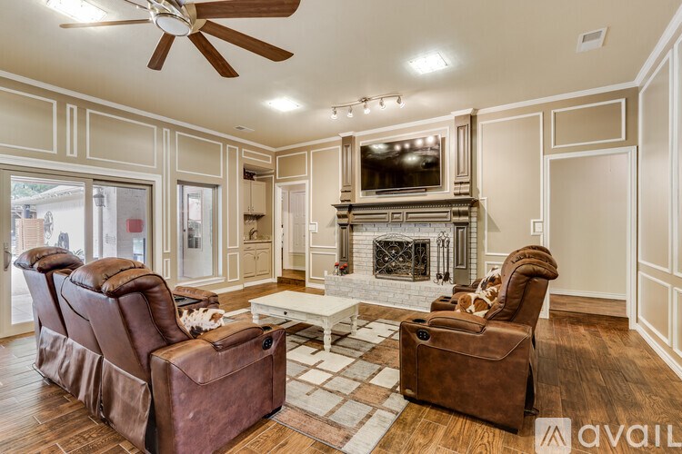 A living room with a fireplace and a television.