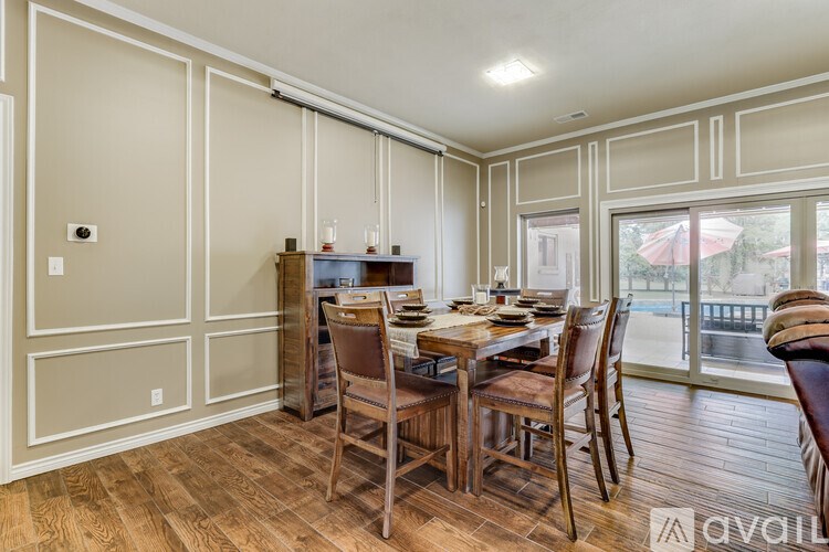 A dining room with a wooden table and chairs.