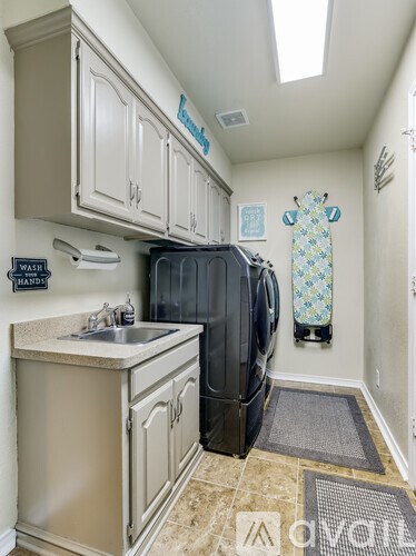 A small kitchen with a black dishwasher and a white sink.