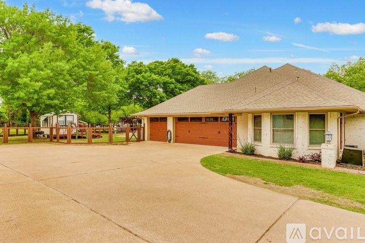 A house with a driveway and a garage is available for rent.